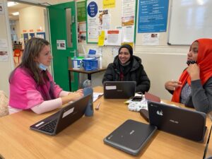 Three ladies at laptops